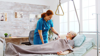 Enfermera ayudando a una mujer en la cama